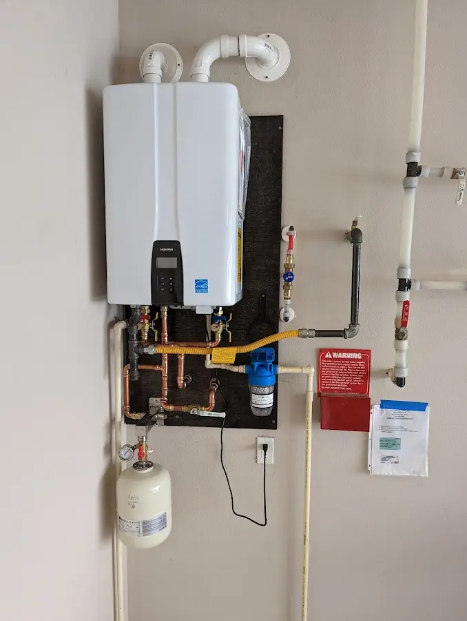 Professional plumber installing copper piping in a Central Falls home